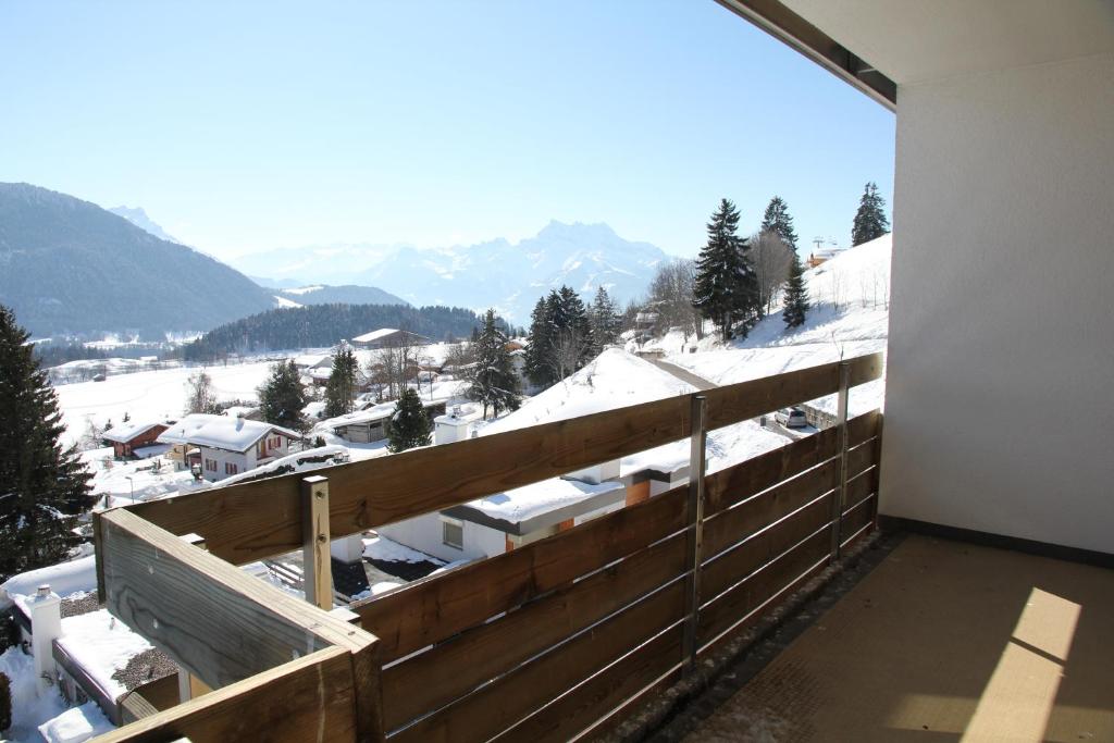 a balcony with a view of a snow covered mountain at Roc d'Orsay D36 in Leysin