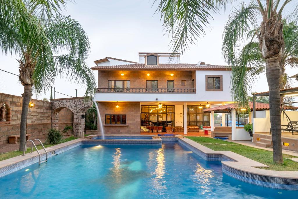 una casa con piscina frente a una casa en Quinta Alondra casa campestre, en Los Sauces