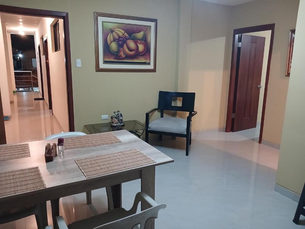 a dining room with a table and a painting on the wall at Suites Sonikikos in Ballenita