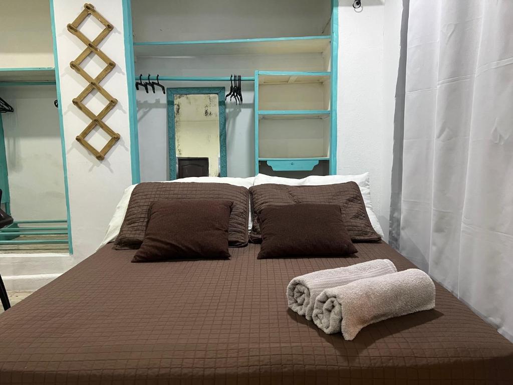 a large bed with two towels on top of it at Apartaestudios norte de barranquilla in Barranquilla