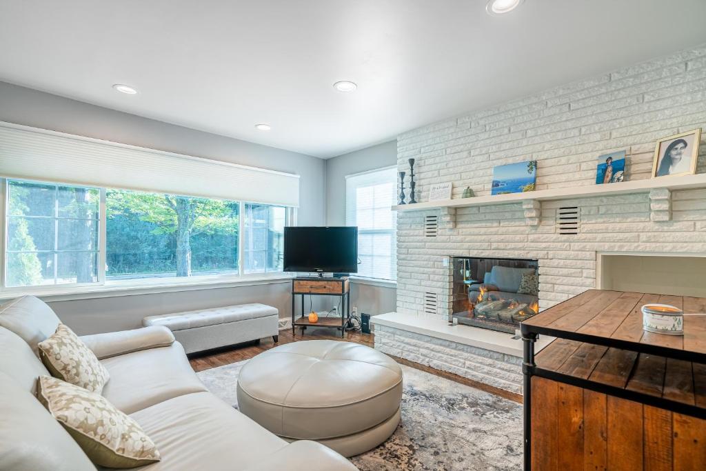 a living room with a couch and a fireplace at Poolside Paradise in South Haven