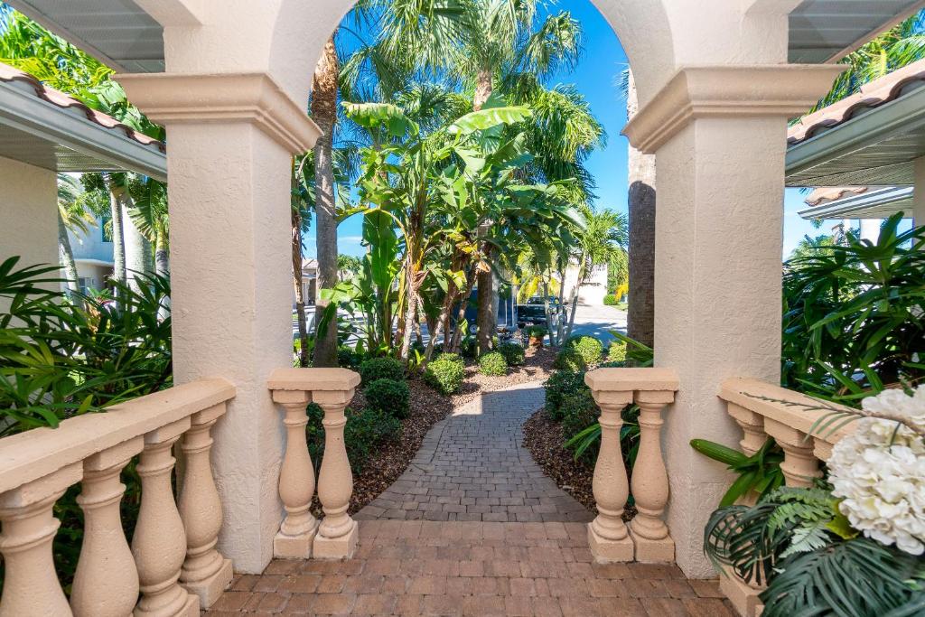 a walkway in a house with palm trees at Villa Hibiscus-Waterfront-Punta Gorda FL in Punta Gorda