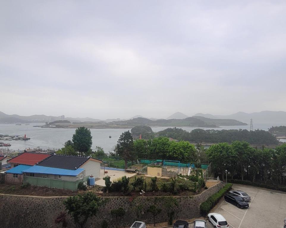 een uitzicht op een waterlichaam met geparkeerde auto's bij Gyeongdo CC and Ocean view in Yeosu