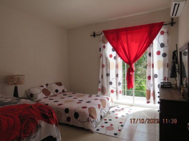 a bedroom with a bed and a window at Brisa de Mar in El Ojito