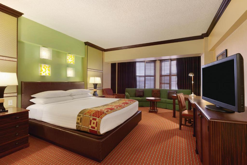 a hotel room with a bed and a flat screen tv at Harrah's Lake Tahoe Hotel & Casino in Stateline