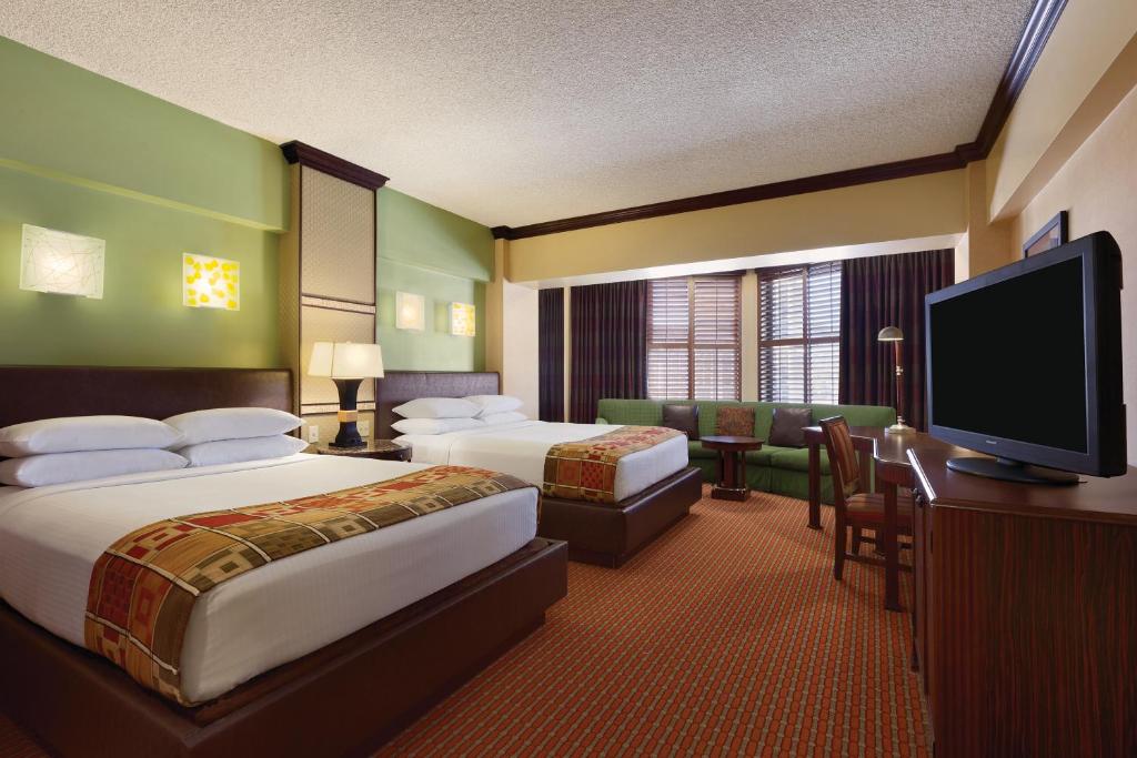 a hotel room with two beds and a flat screen tv at Harrah's Lake Tahoe Hotel & Casino in Stateline