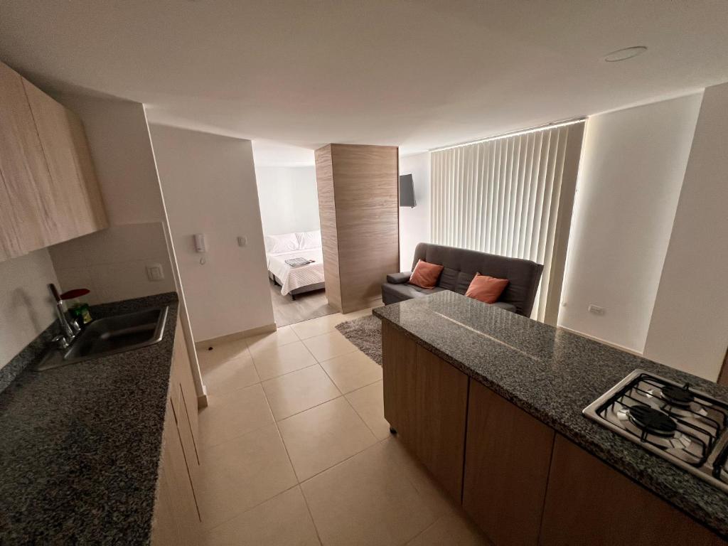 a kitchen with a counter top and a living room at Urban Manizales 703 in Manizales