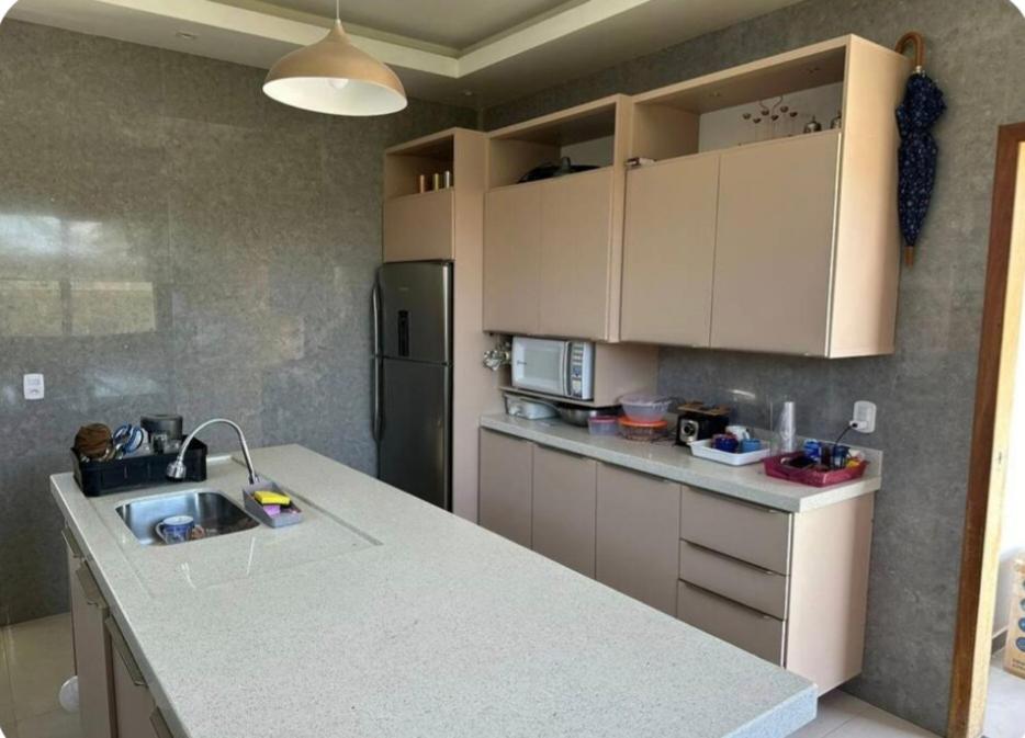 a kitchen with a counter and a refrigerator at Residencial Mirandinha in Boa Vista