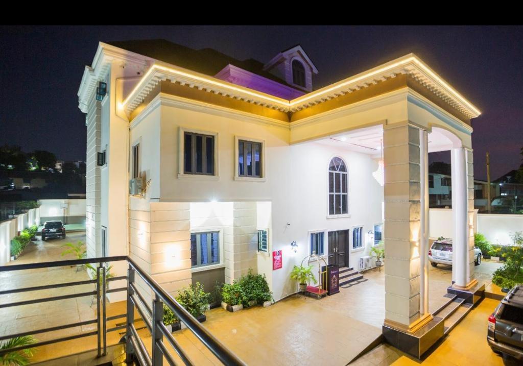 a large white house with a balcony at night at ED&DRE Luxuria Hotel in Ibadan