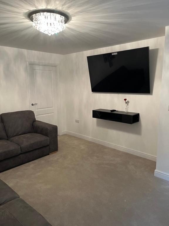a living room with a couch and a flat screen tv at 28 croft holm 