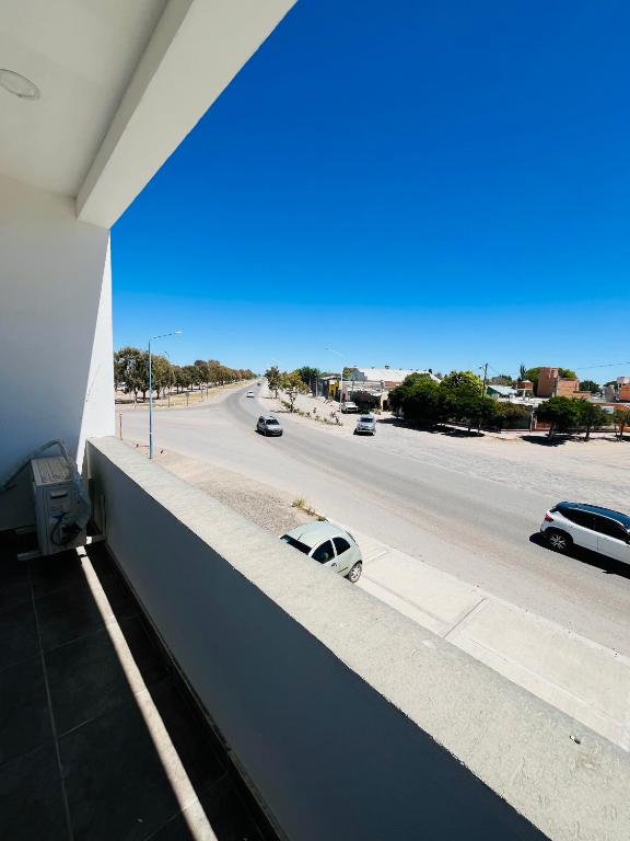 a white car parked on the side of a street at Atuel Alojamiento in San Antonio Oeste
