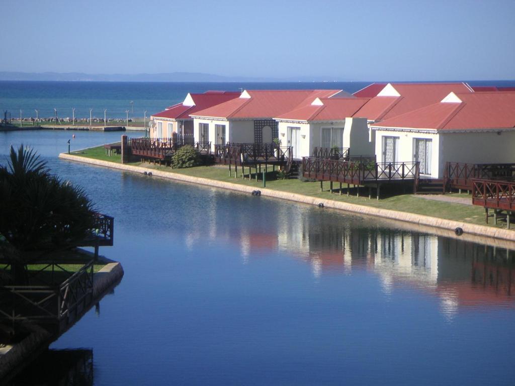 une rangée de maisons à côté d'une masse d'eau dans l'établissement WatersideLiving MS11, à Jeffreys Bay