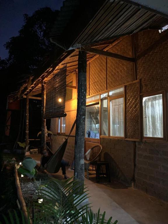 a house with a hammock outside of it at night at rk.homestay in Rantepao