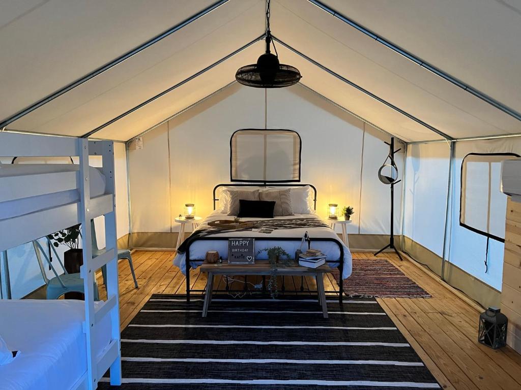 a bedroom with a bed in a tent at Luxury Glamping Tents @ Lake Guntersville State Park in Guntersville