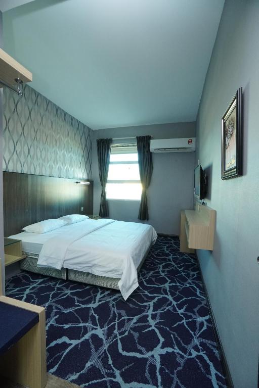 Postel nebo postele na pokoji v ubytování Regent Hotel
