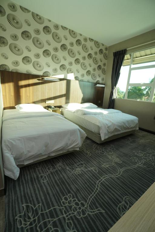 Postel nebo postele na pokoji v ubytování Regent Hotel