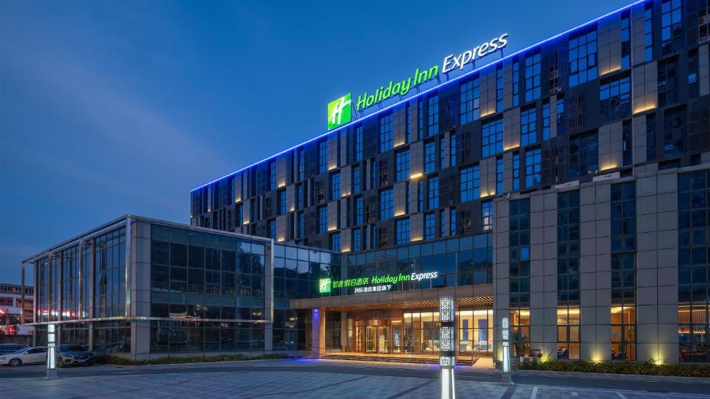 a large building with a sign on top of it at Holiday Inn Express Huangshi Cihu Lake, an IHG Hotel in Huangshi