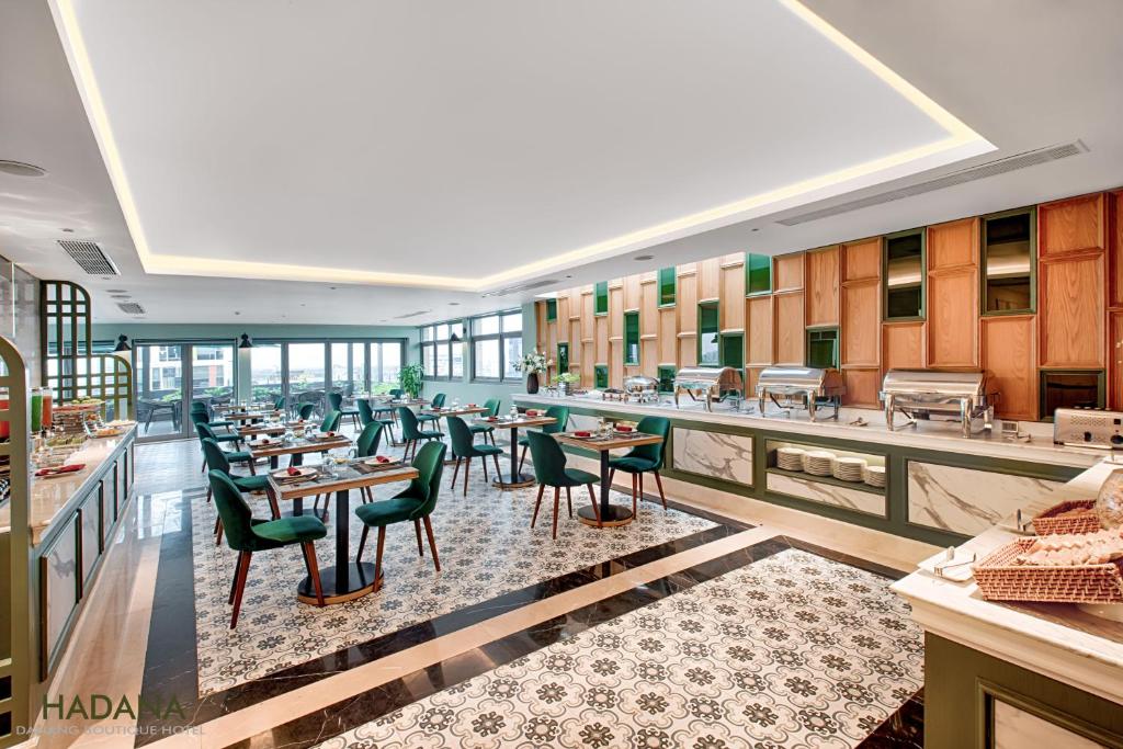 A bright breakfast dining room with teal chairs, buffet counters and broad windows.