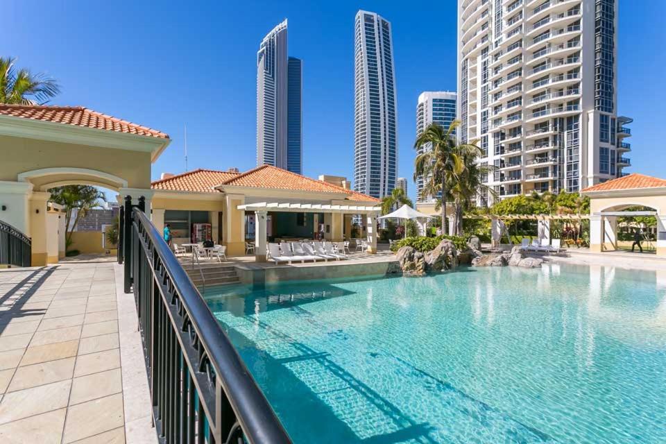 a swimming pool in a resort with tall buildings at Chevron Renaissance - Self Contained Apartments - Wow Stay in Gold Coast