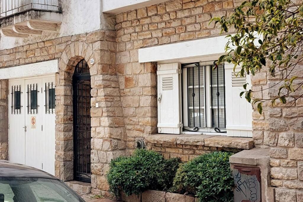 a brick building with a white door and windows at Totem in Mar del Plata