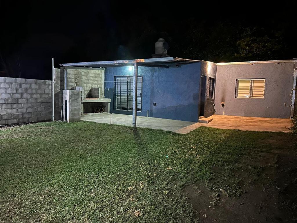 a blue house with a yard at night at El rincon de Valle in Valle Hermoso