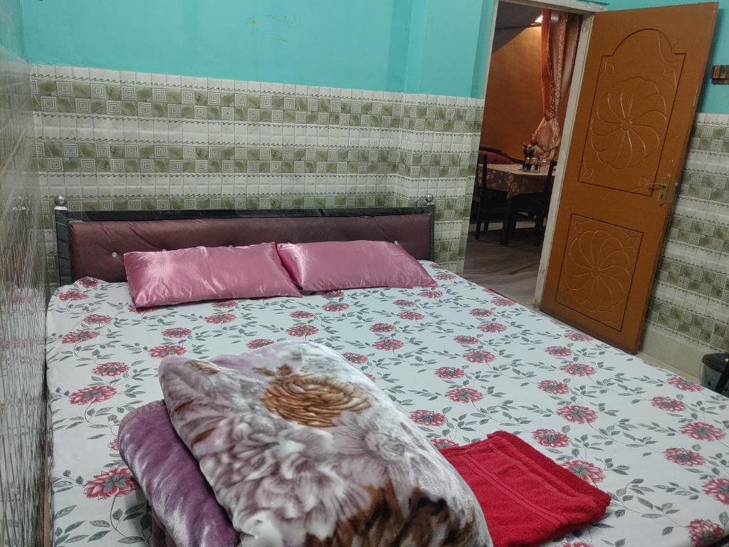 een slaapkamer met een bed met een dekbed en kussens bij Comfort Inn Kamakhya Jn in Guwahati