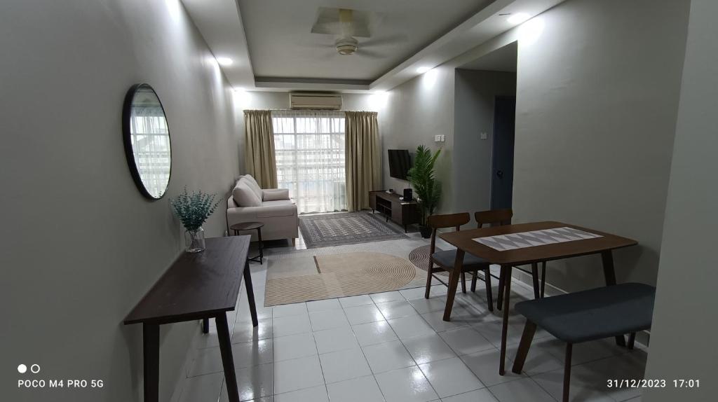 a living room with a table and a couch at Homestay Saujana Aster @ Putrajaya in Putrajaya
