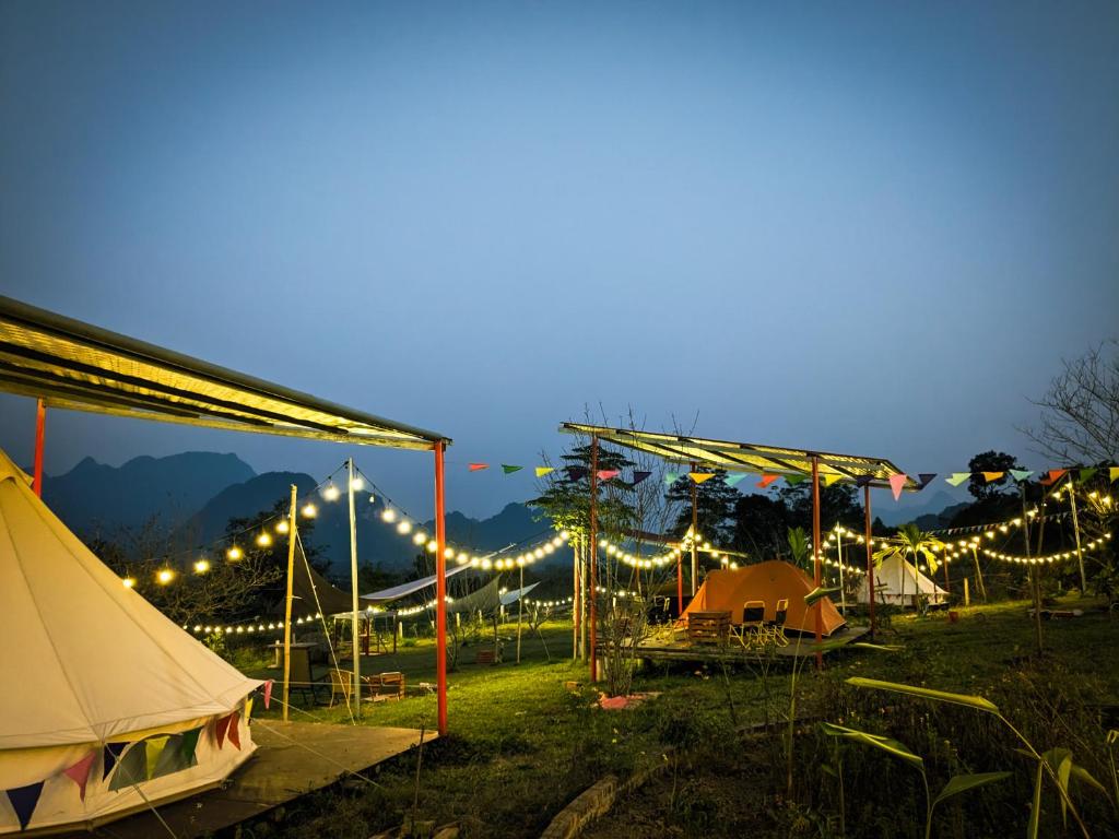 een groep tenten in een veld met verlichting bij Wind Hill Campsite in Ha Giang