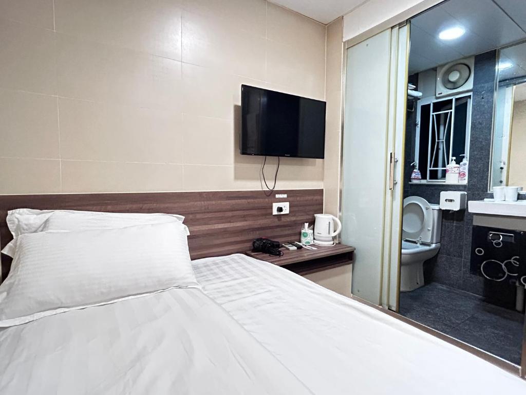 Postel nebo postele na pokoji v ubytování 香港星星旅馆 2202 Guesthouse