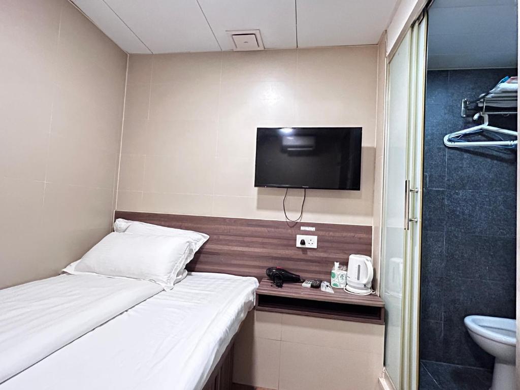 Postel nebo postele na pokoji v ubytování 香港星星旅馆 2202 Guesthouse