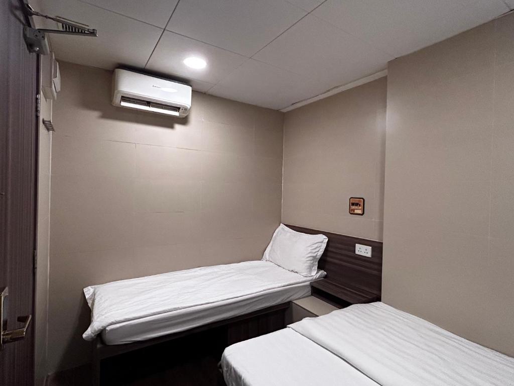 Postel nebo postele na pokoji v ubytování 香港星星旅馆 2202 Guesthouse