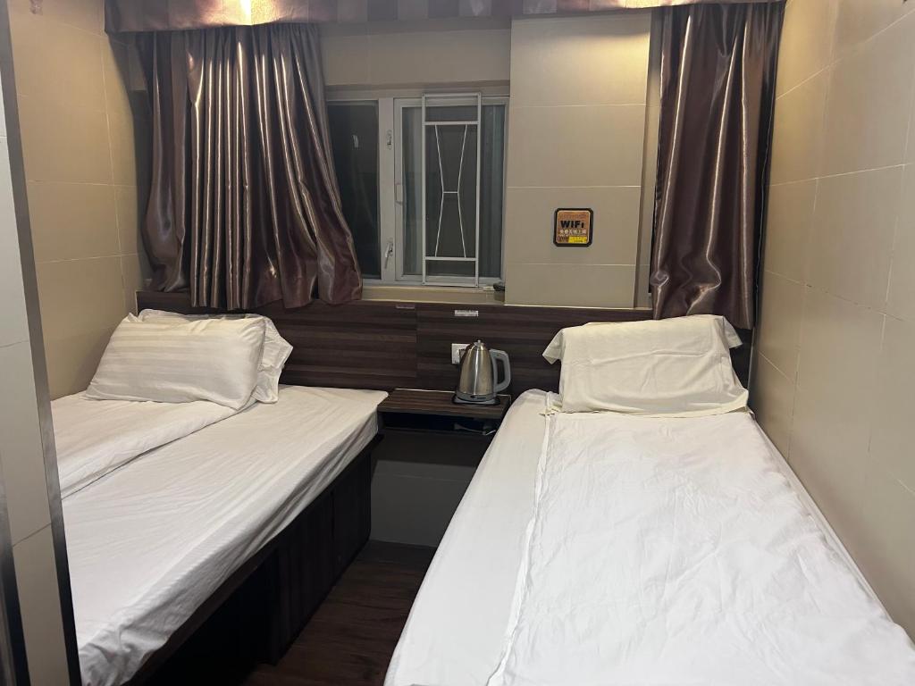 Postel nebo postele na pokoji v ubytování 香港星星旅馆 2202 Guesthouse