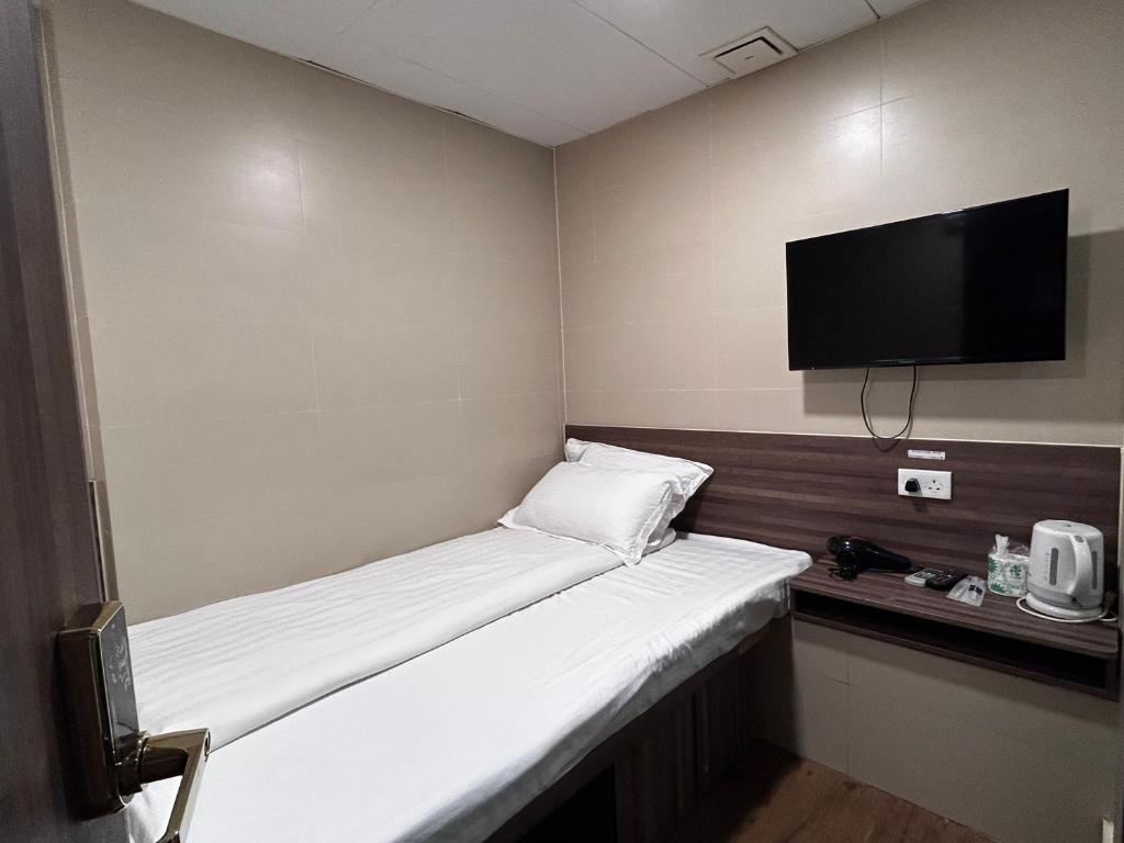 Postel nebo postele na pokoji v ubytování 香港星星旅馆 2202 Guesthouse