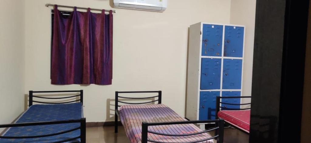 ヴィジャヤワーダにあるRAYUDUGARILLU MEN'S DELUXE HOSTELの二段ベッド2台と窓が備わる客室です。