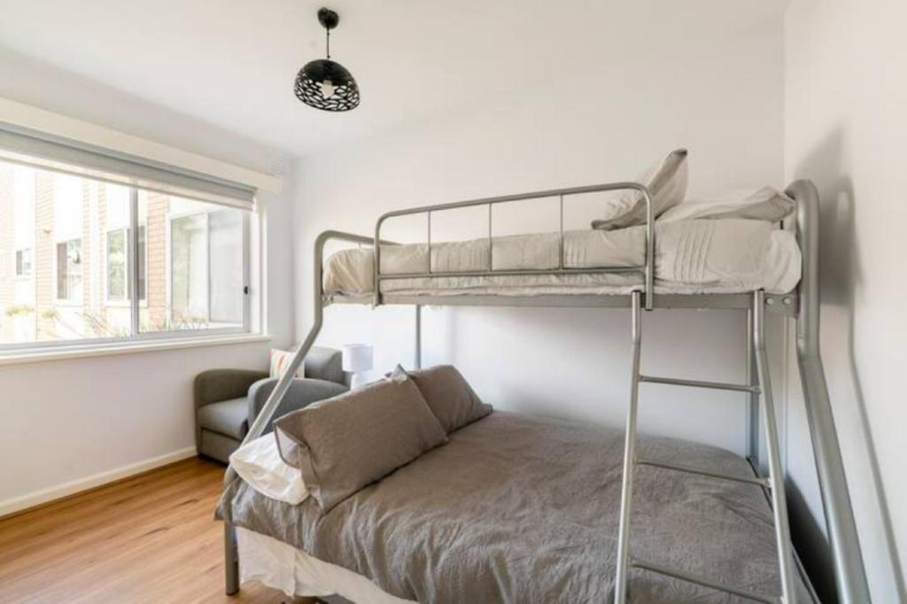 - une chambre avec des lits superposés et un canapé dans l'établissement Unwind in style only 7km from CBD, à Melbourne
