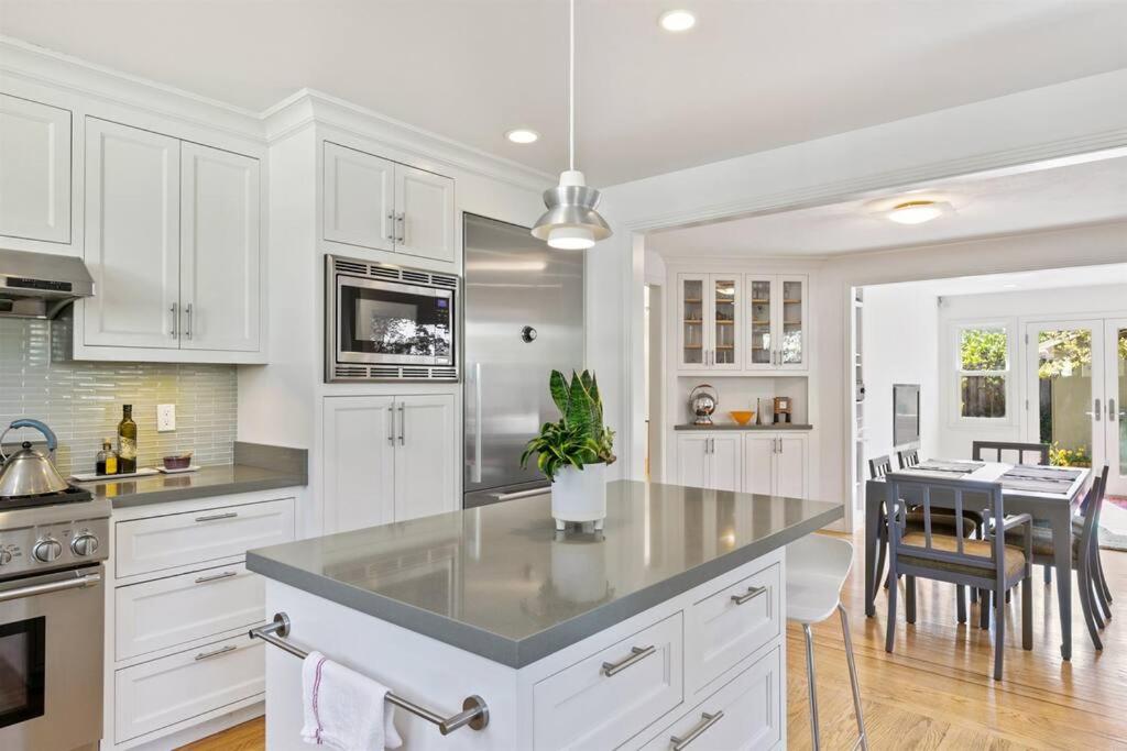 a kitchen with white cabinets and a dining room at Casita Palo Alto - 2 Bed 2 Bath / Private Back Yard in Palo Alto