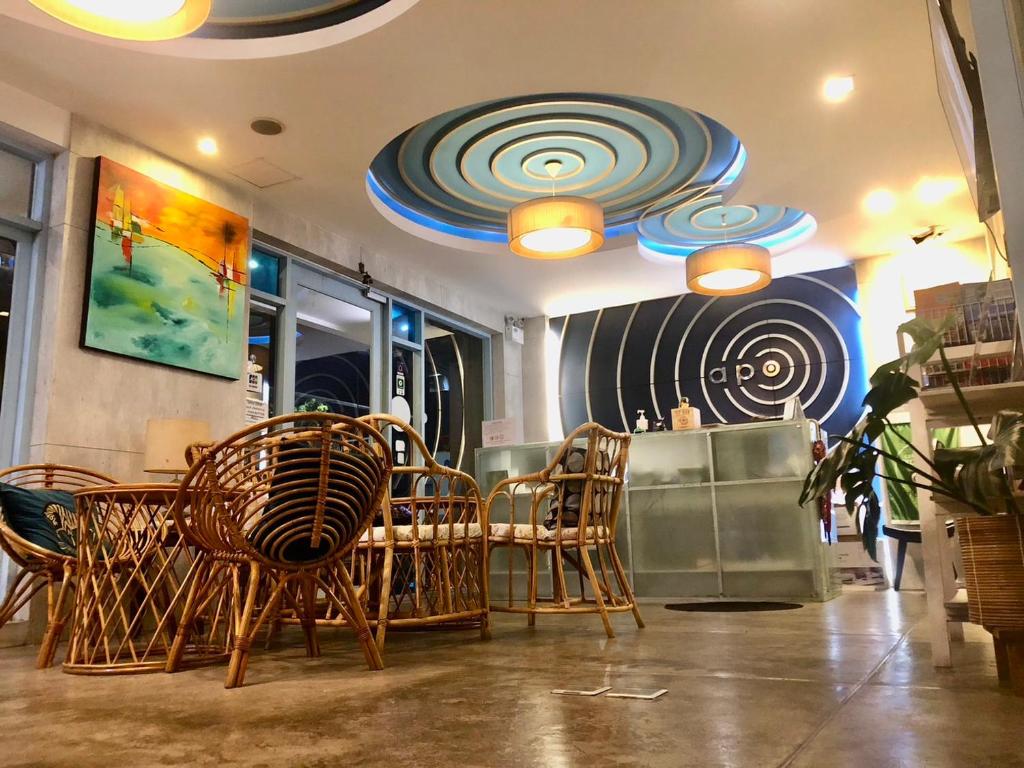 a dining room with chairs and a table in a restaurant at Apo Hotel in Krabi town