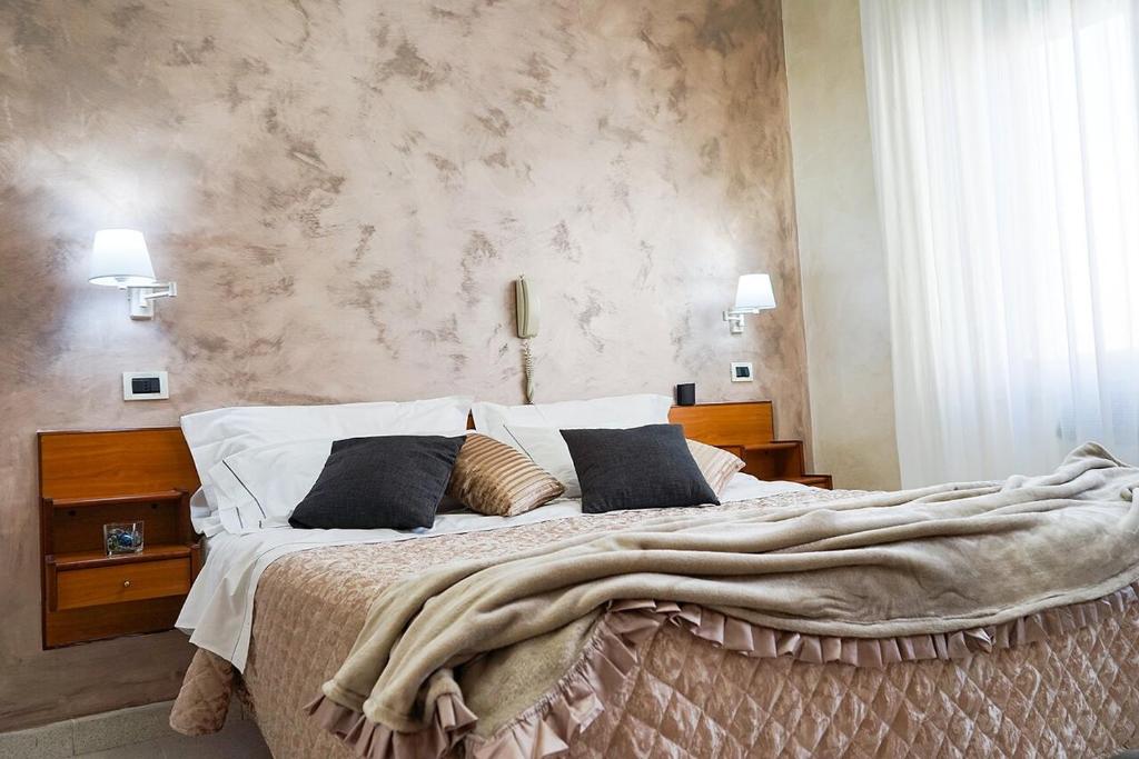 - une chambre avec un grand lit et une couverture dans l'établissement Hotel Marconi, à Fiuggi