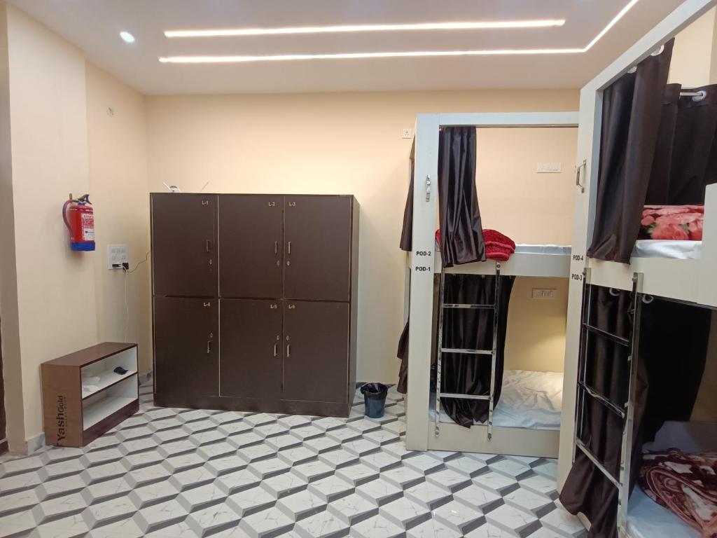 a room with two bunk beds and a mirror at Kashi Vandanam Homestay in Varanasi