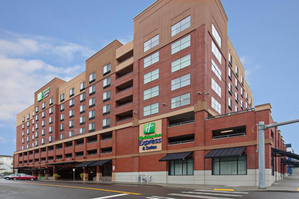 a large red brick building on a city street at Holiday Inn Express & Suites Tacoma Downtown, an IHG Hotel in Tacoma