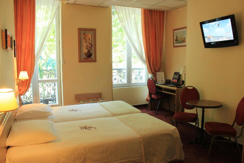 Postel nebo postele na pokoji v ubytování Hôtel Foch