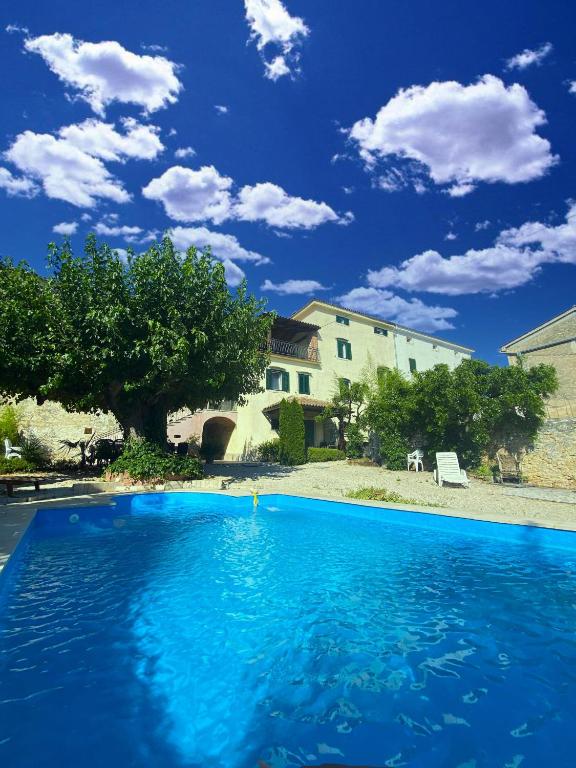 a large blue swimming pool in front of a building at Villa Angiolina in Višnjan