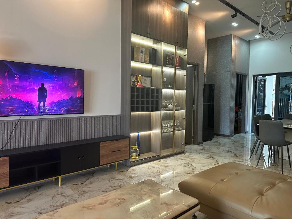 a living room with a flat screen tv on a wall at Trị An Villa in Xã Trảng Bôm