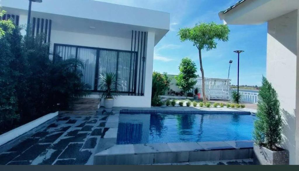 a swimming pool in the backyard of a house at Riverfront villa & pool kampot in Kampot