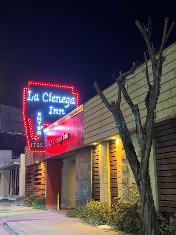 a lit up sign on the side of a building at La Cienega Inn Motel in Los Angeles
