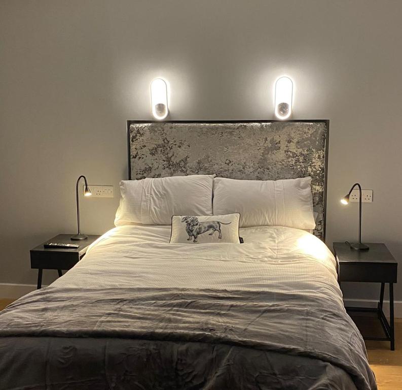 a bedroom with a large bed with two lamps at Shanroe Accommodation in Mullaghbane