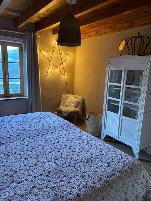 a bedroom with a white bed and a window at Grande Chambre d'hôte in Chalmazel Jeansagniere