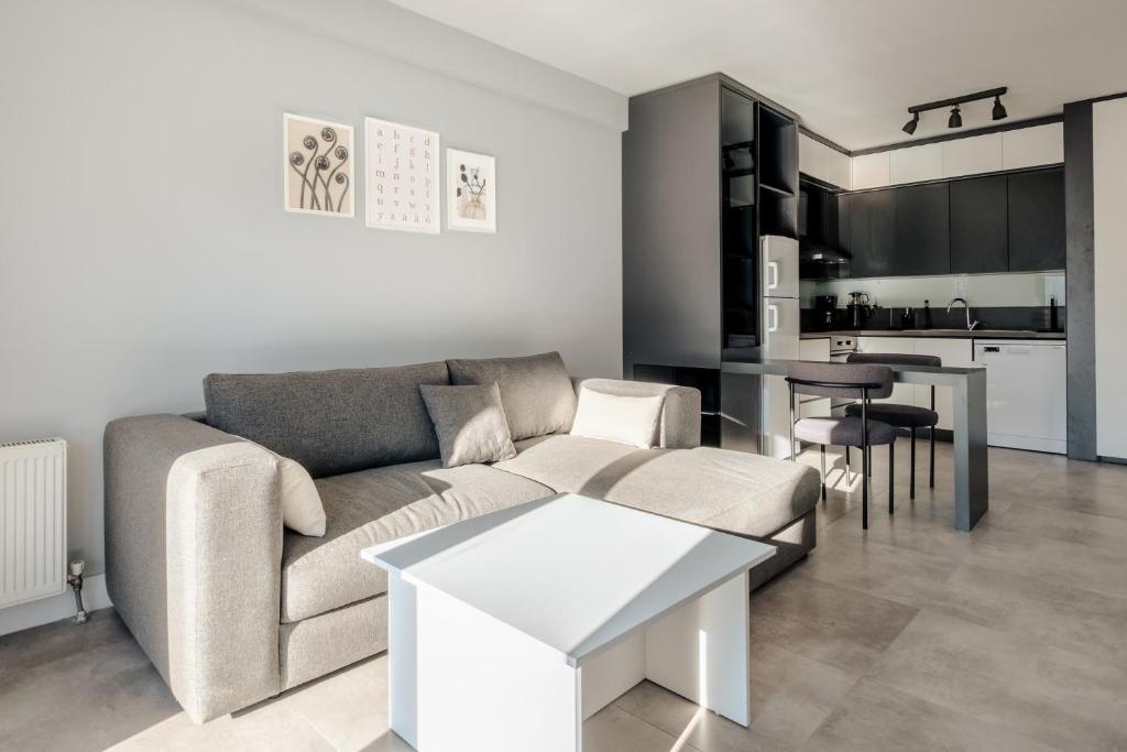 a living room with a couch and a table at Luminous Flat 7 min to Arcadium Mall in Ankara in Ankara