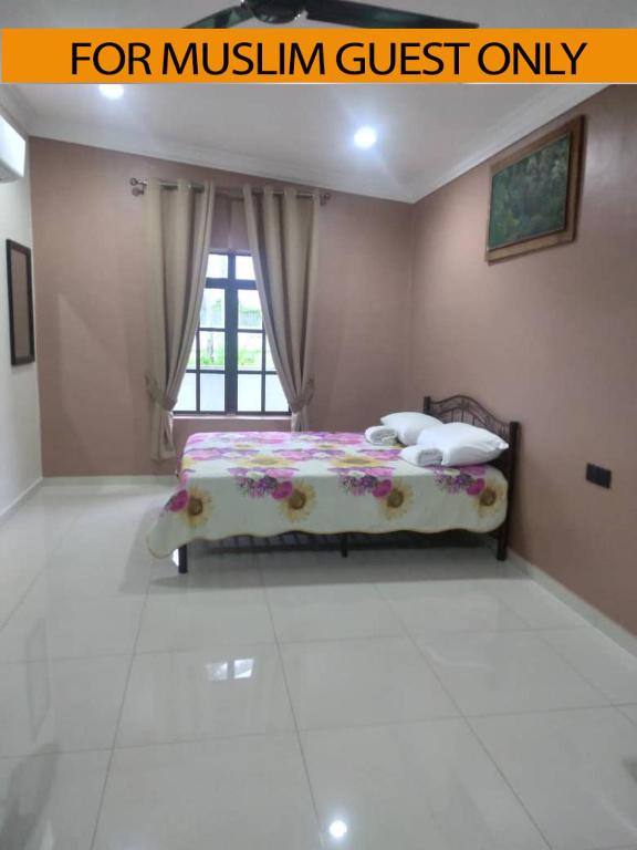 a bedroom with a bed in a room at Yasmeen Studio Roomstay Kijal - Room 2 - FOR TWO PERSON ISLAM GUEST ONLY in Kijal