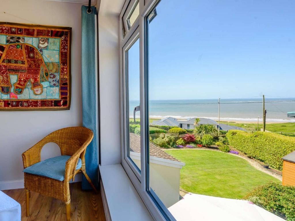 a room with a window looking out at the ocean at 4 Bed in Ogmore-By-Sea 87141 in Saint Brides Major
